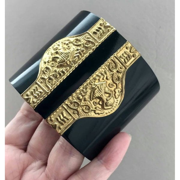 Black Lucite with embossed ornate gold tone Egyptian Design elements in a Wide Cuff Bracelet
